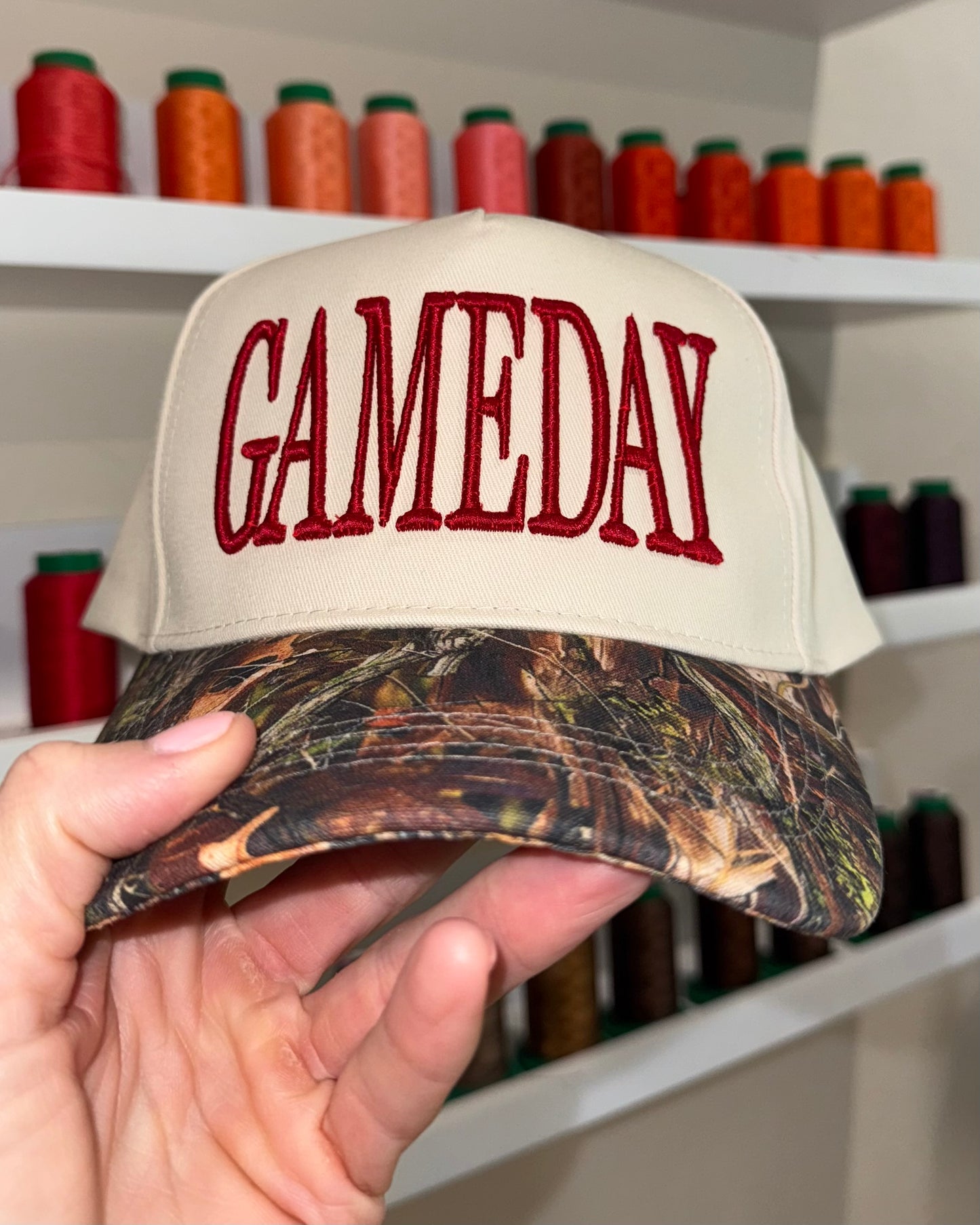GAMEDAY Puff Embroidered Hat on Canvas Trucker with Camo Bill