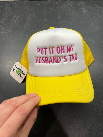 Put It On My Husband’s Tab Trucker Hat